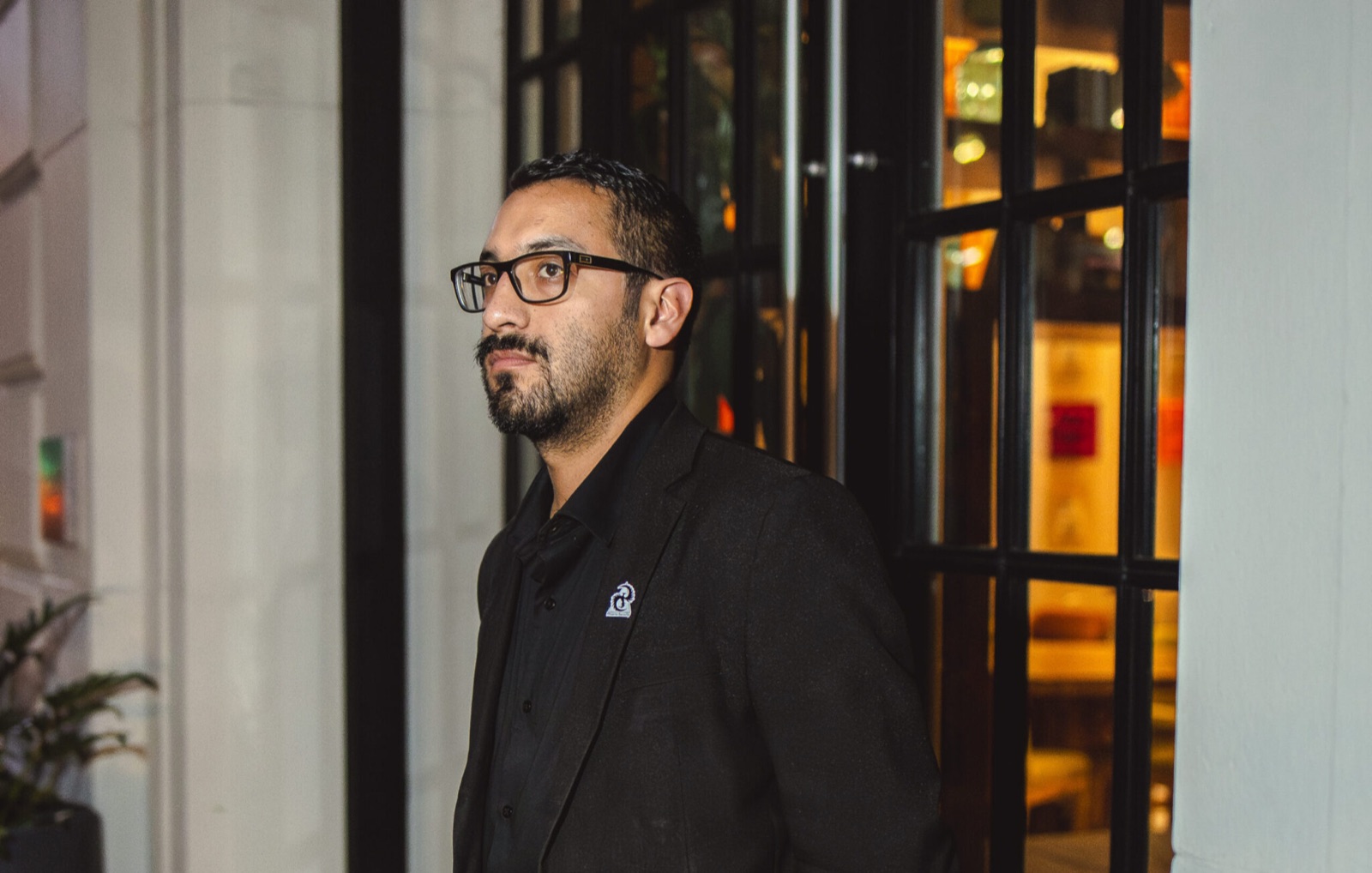 Plainclothes Valcor Security officer at a hotel entrance at night