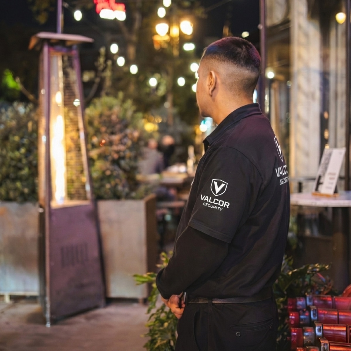 Valcor Security officer at a busy restaurant patio at night